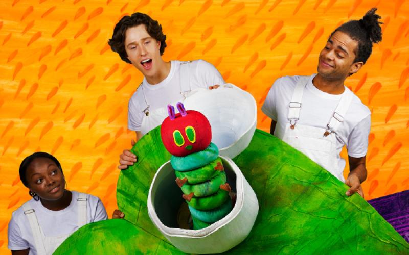 A green Very Hungry Caterpillar with 3 actors